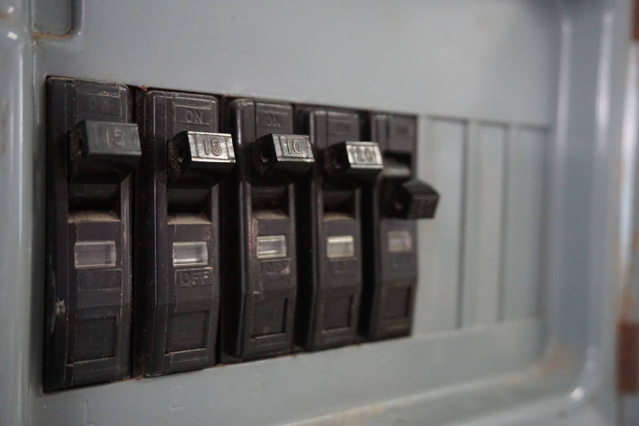 A close up of a circuit breaker on a wall.