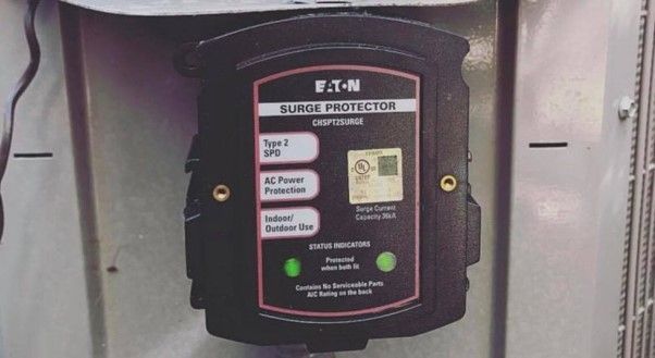 A f.t.n surge protector is mounted on a wall