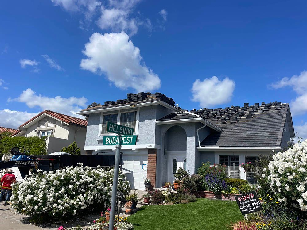A house with a roof that has been damaged by a fire.