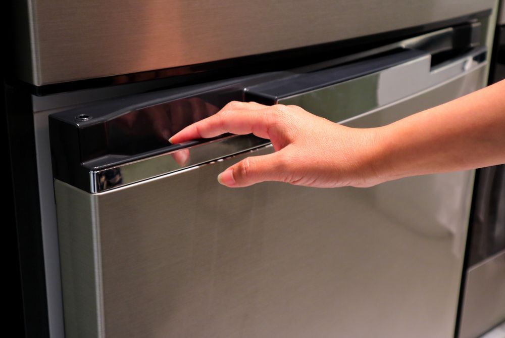 Woman Opening a Refrigerator Door — Brod’s Refrigeration & Air Conditioning in Terramungamine, NSW