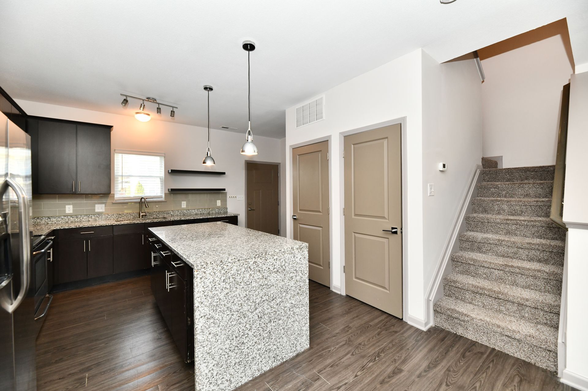 A kitchen with stainless steel appliances and granite counter tops