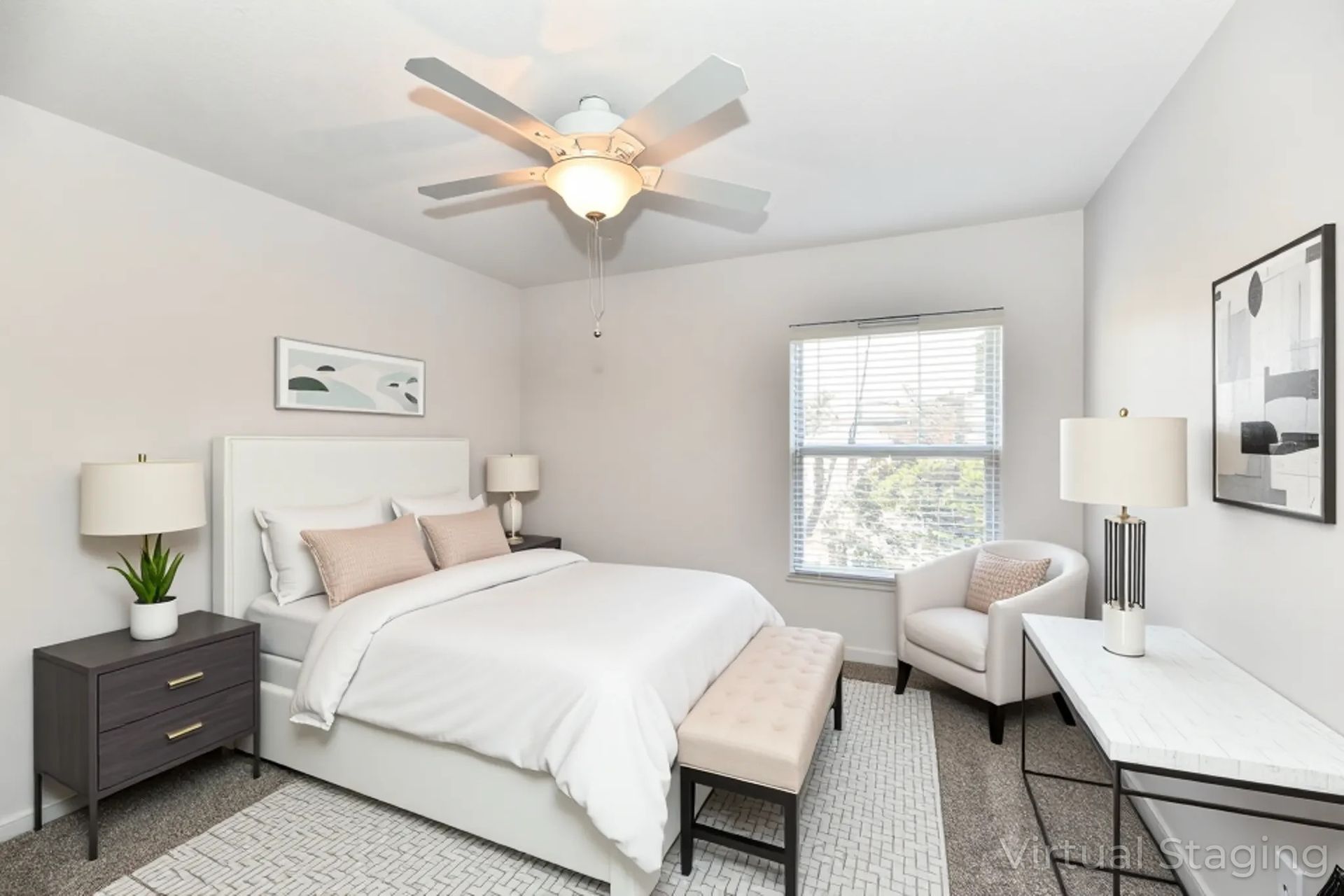 A living room with a kitchen and stairs in a house.