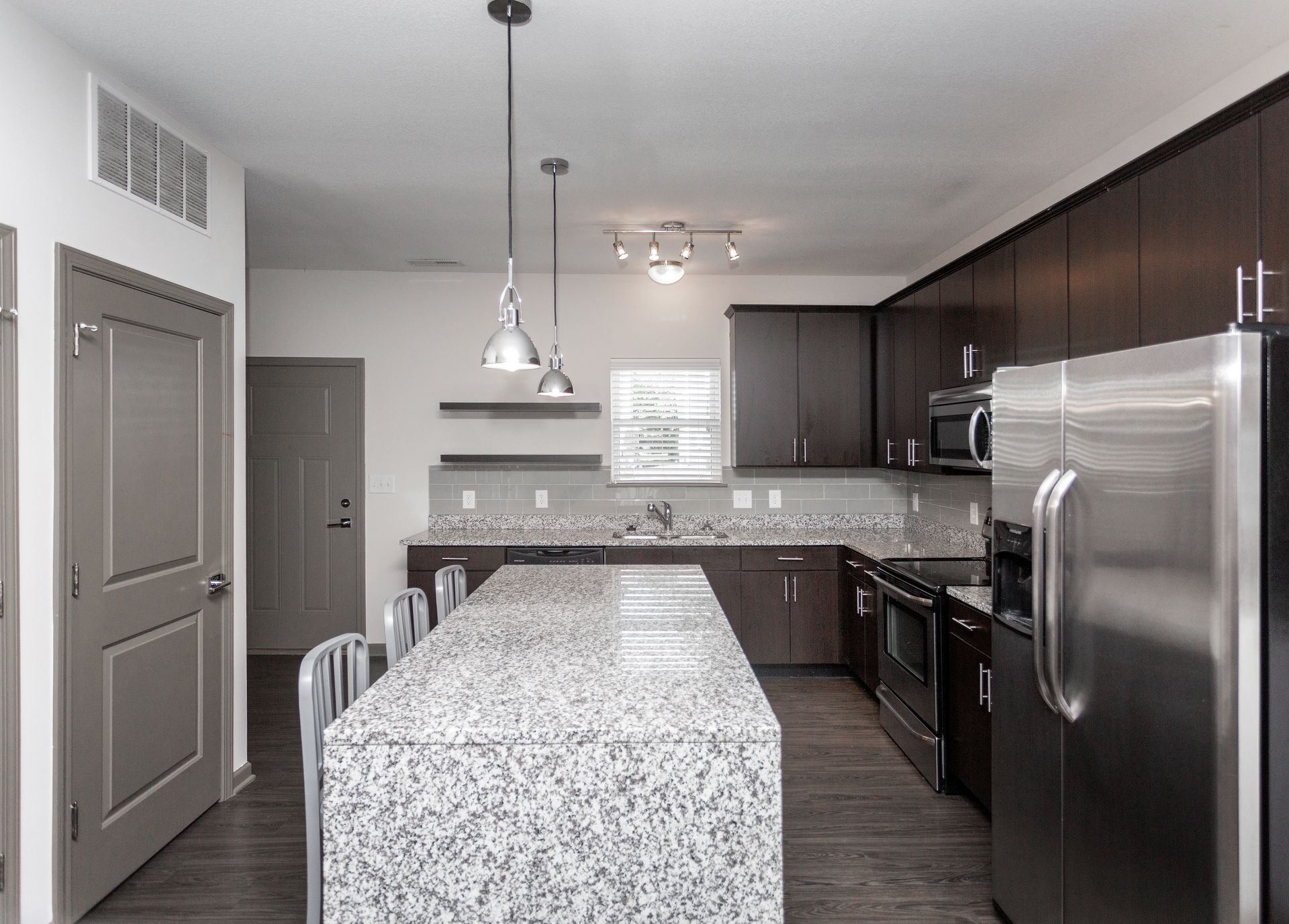 A kitchen with granite counter tops and stainless steel appliances