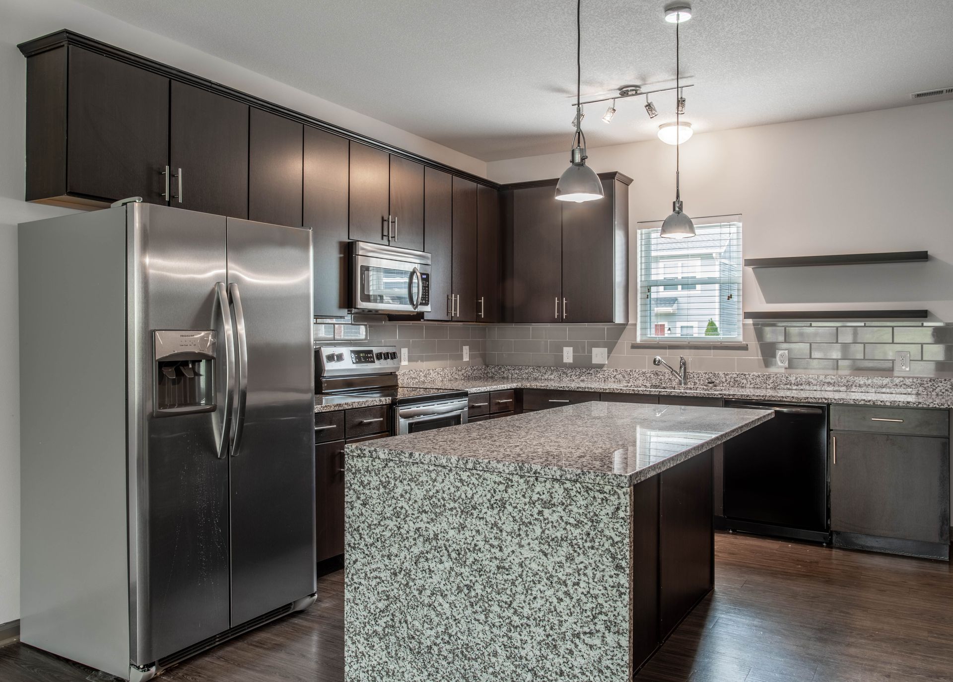 A kitchen with stainless steel appliances and granite counter tops