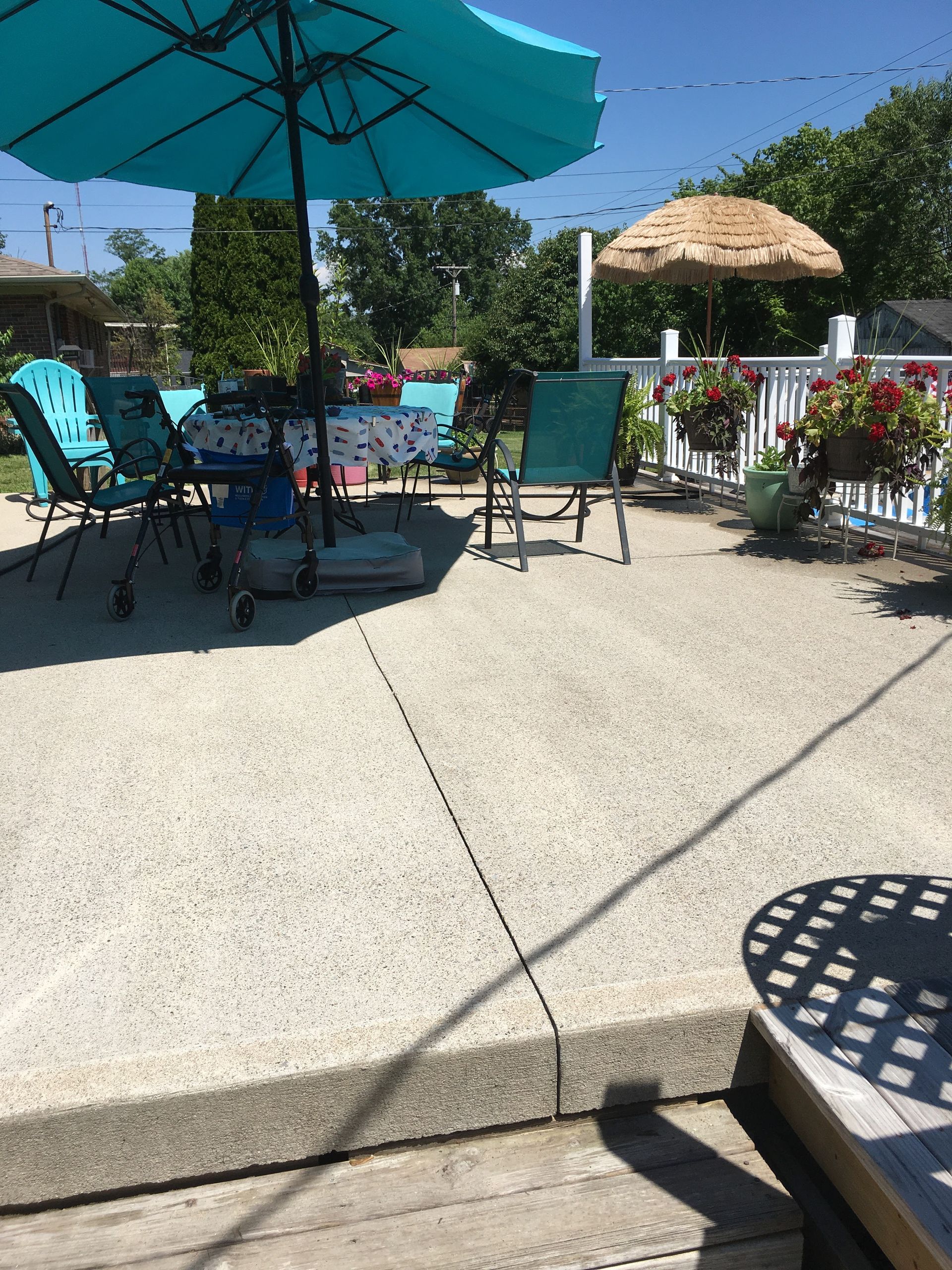 A patio with a table and chairs under an umbrella
