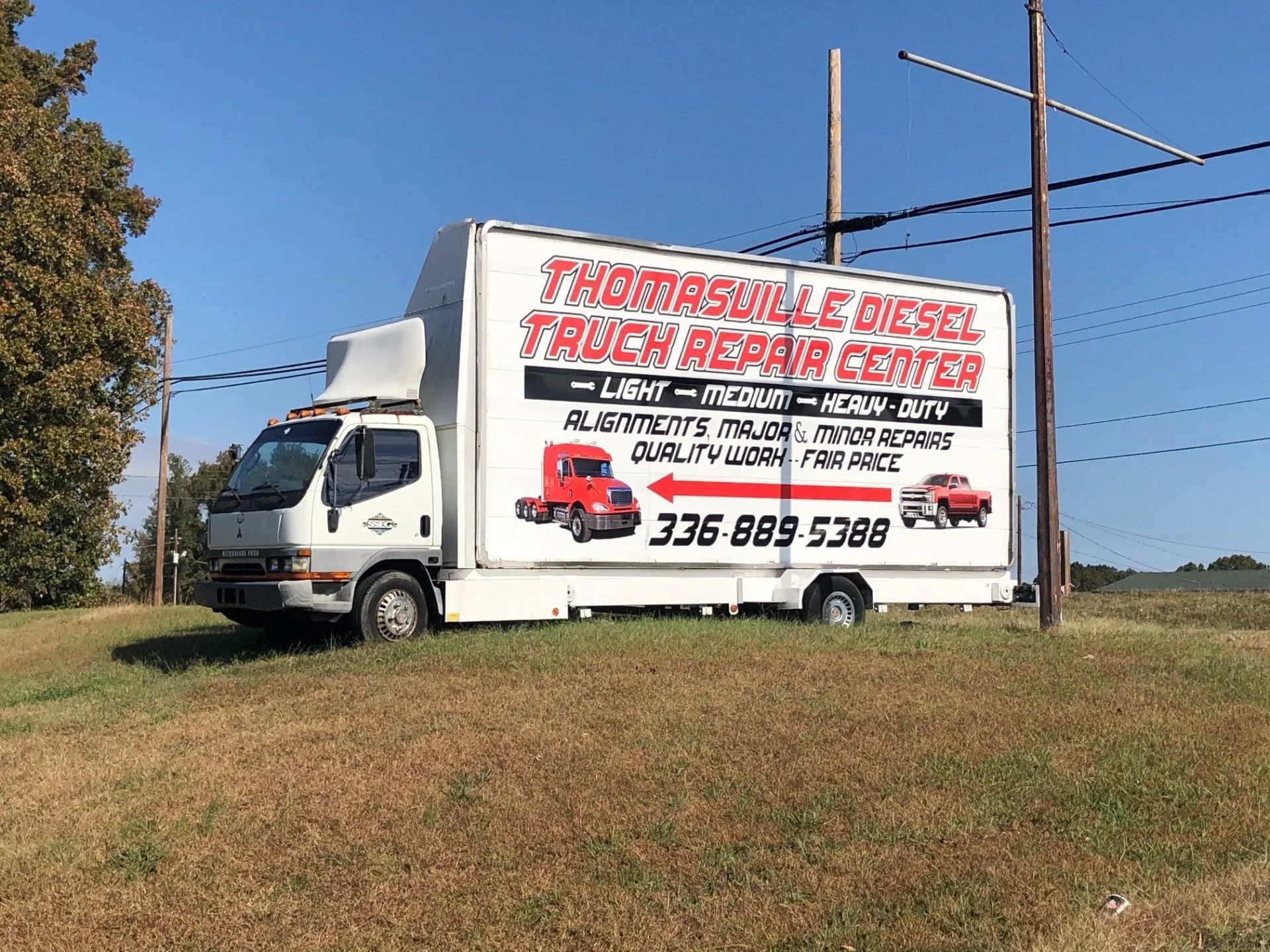 A white truck with a red and white sign on it — Thomasville, NC — Thomasville Diesel