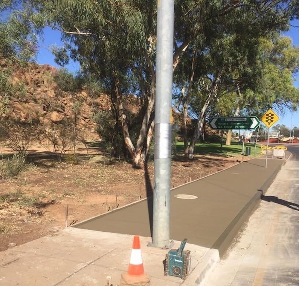 A Street With A Pole And A Traffic Cone On It — Heartland Concrete In Gillen, NT