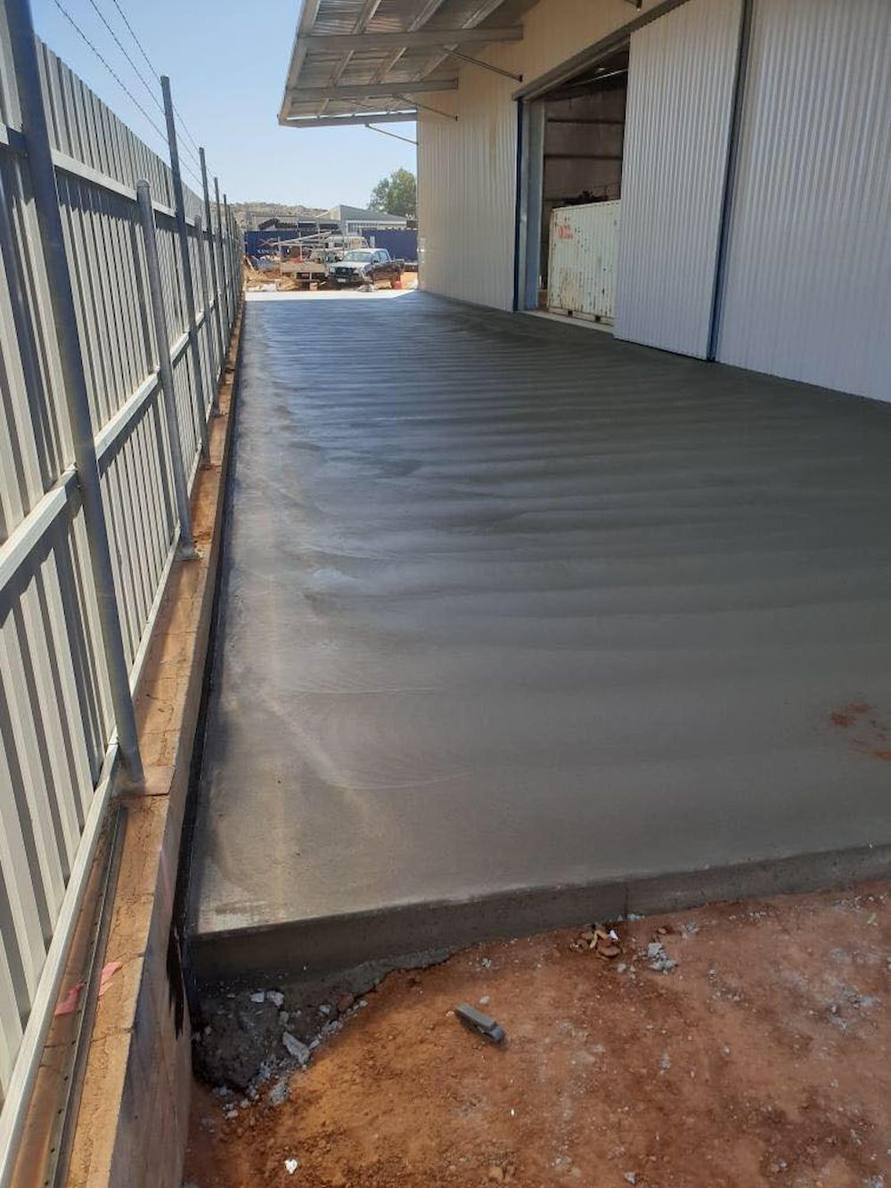 A Concrete Walkway Is Being Built In Front Of A Building — Heartland Concrete In Gillen, NT