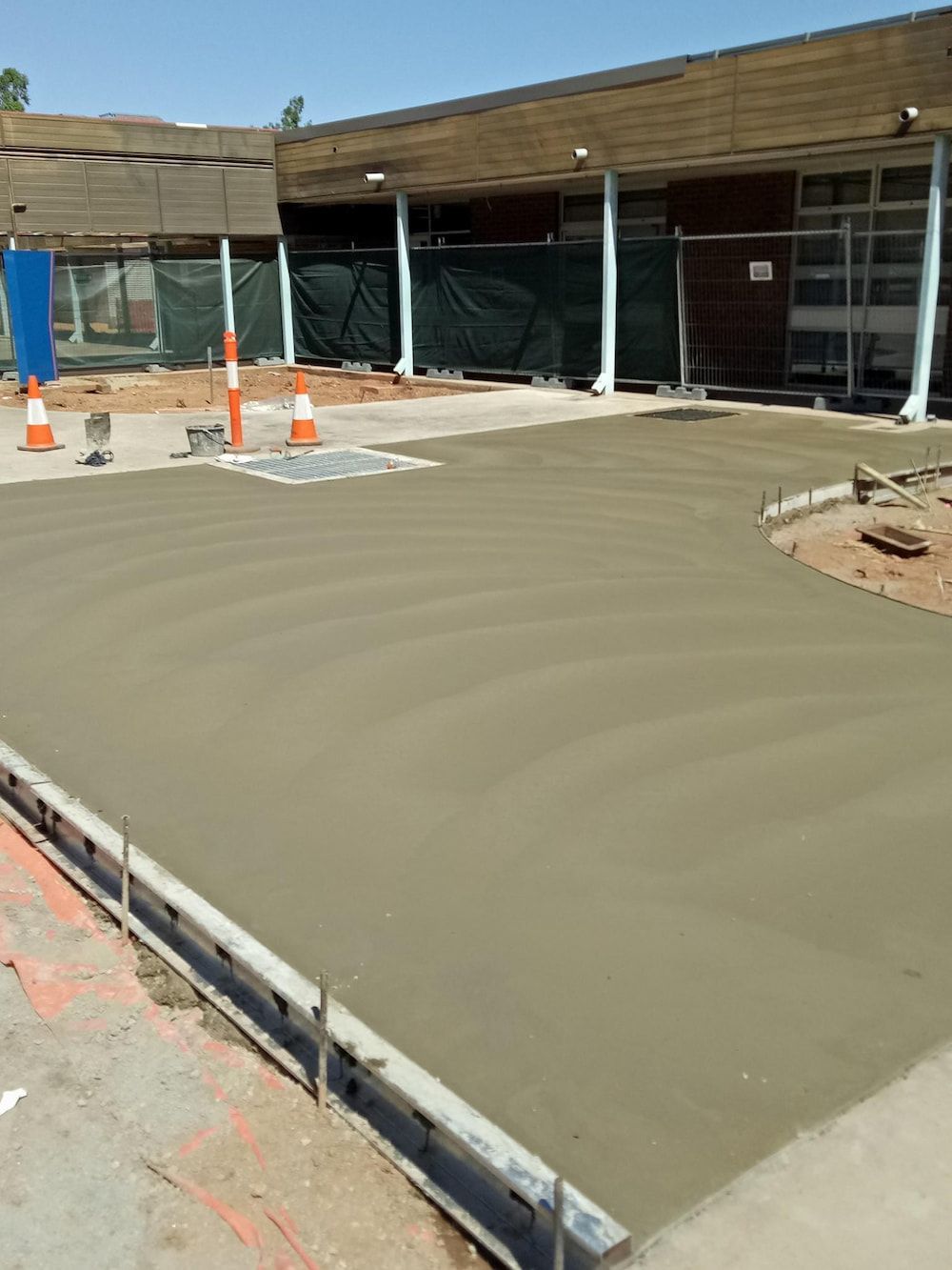 A Concrete Driveway Is Being Built In Front Of A Building — Heartland Concrete In Gillen, NT