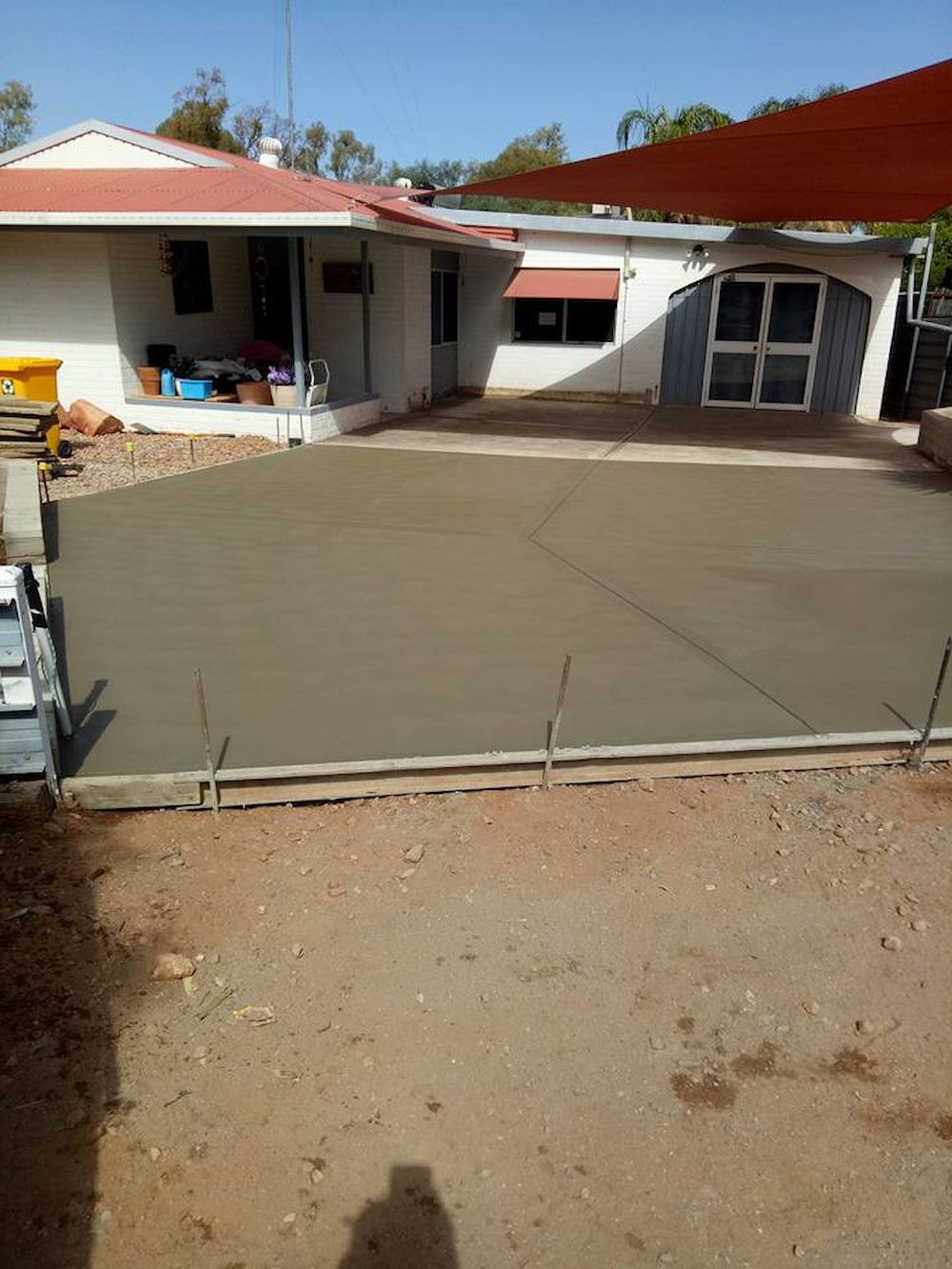 A Concrete Driveway Is Being Built In Front Of A House — Heartland Concrete In Gillen, NT