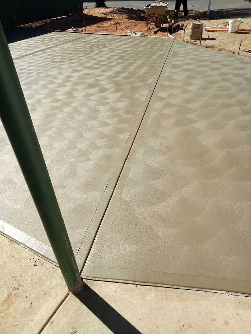 A Concrete Driveway With A Wheelbarrow — Heartland Concrete In Gillen, NT