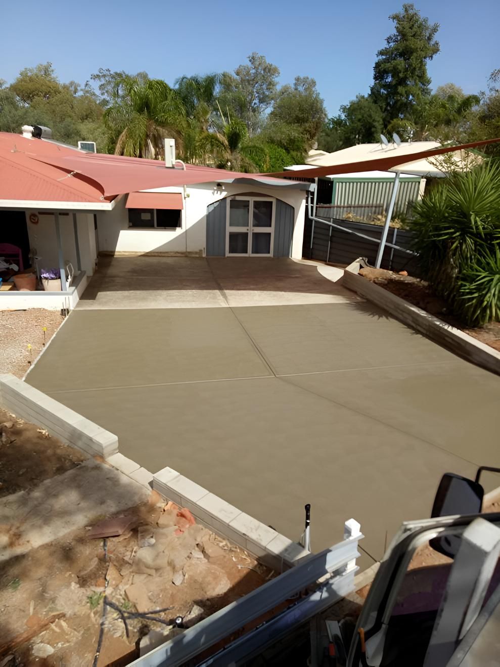 A Concrete Driveway Is Being Built In Front Of A House — Heartland Concrete In Gillen, NT