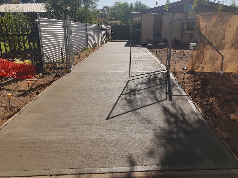 A Concrete Driveway Is Being Built In Front Of A House — Heartland Concrete In Gillen, NT