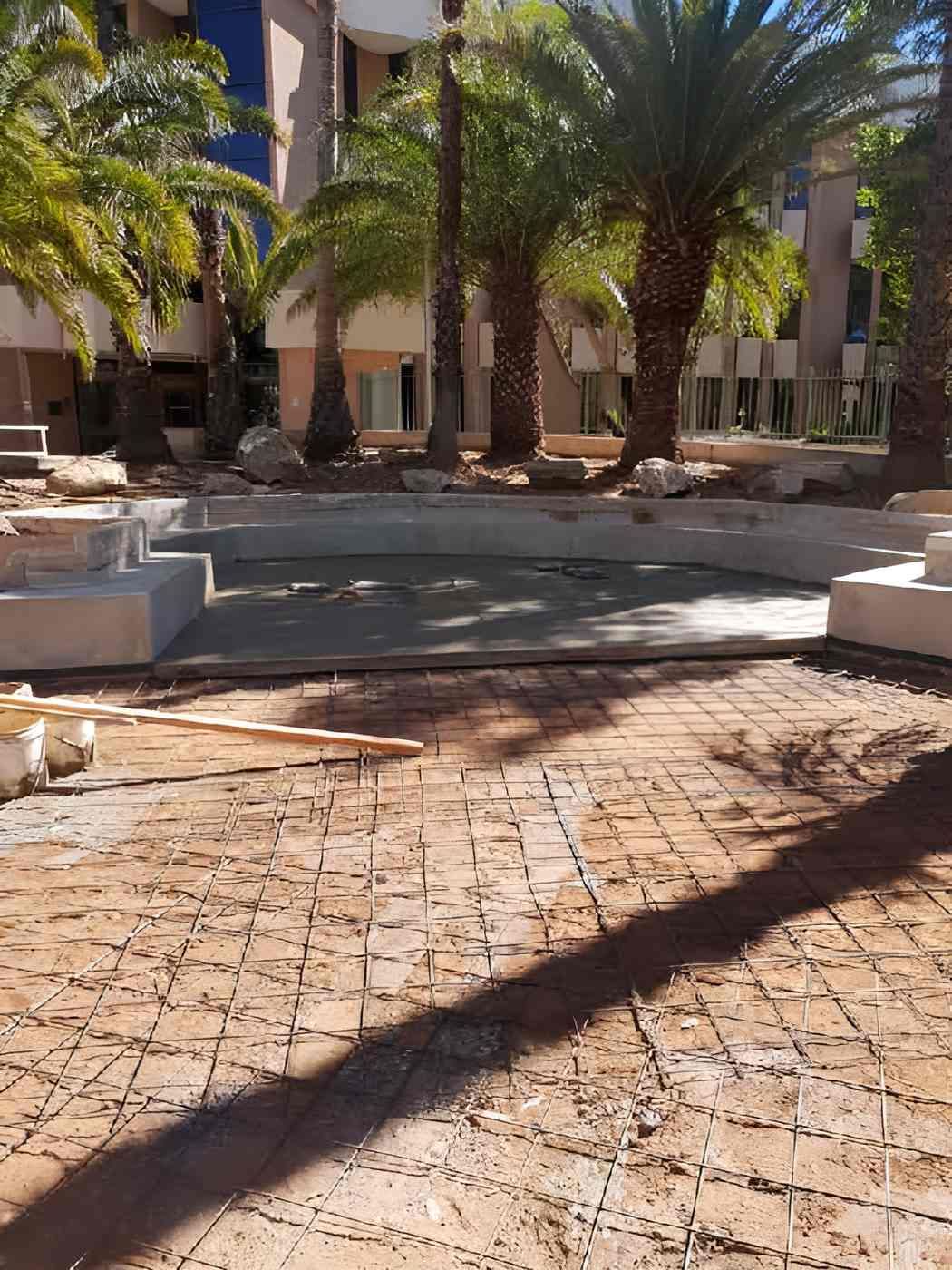 A Brick Walkway With Palm Trees In The Background — Heartland Concrete In Gillen, NT