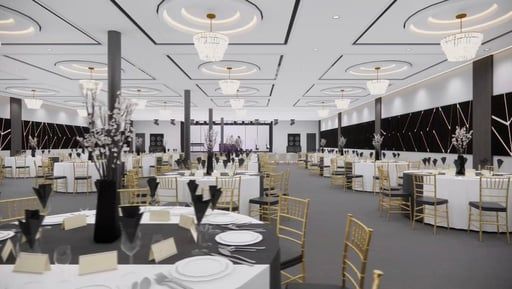 An elegant, spacious banquet hall set for a formal event with round tables, gold chairs, and modern lighting fixtures.
