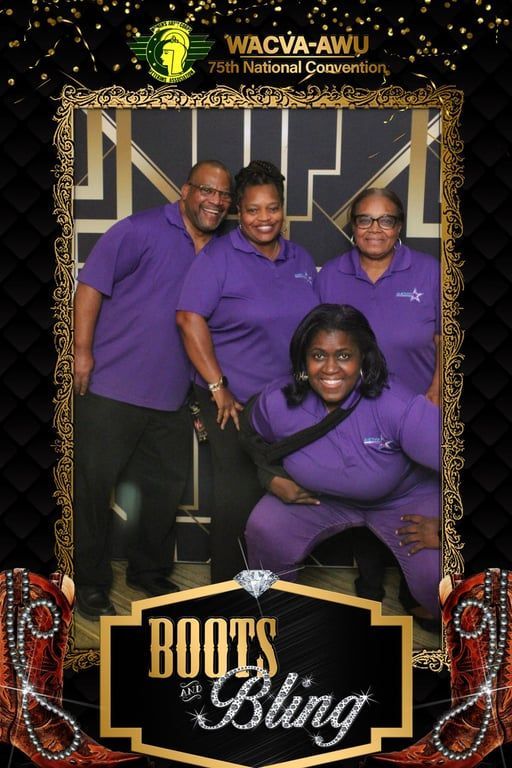 Four people in purple shirts smile inside a photo booth frame.