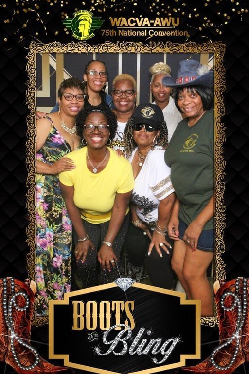 A group of eight people smiling in a photo booth frame decorated with gold borders, confetti, and cowboy boot graphics.