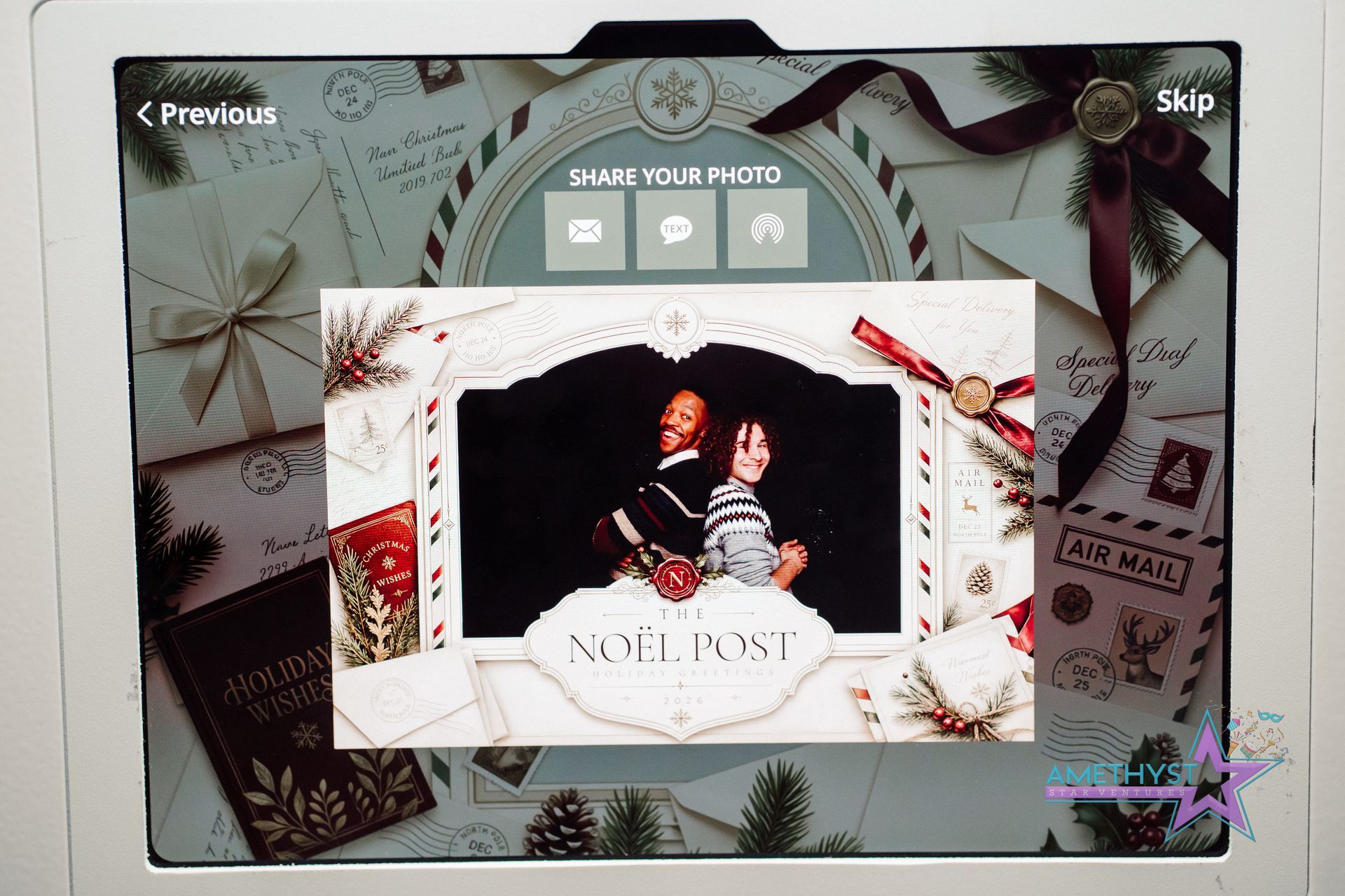 Holiday-themed greeting card with a couple in a framed photo and the words “NOEL POST” on a snowy design