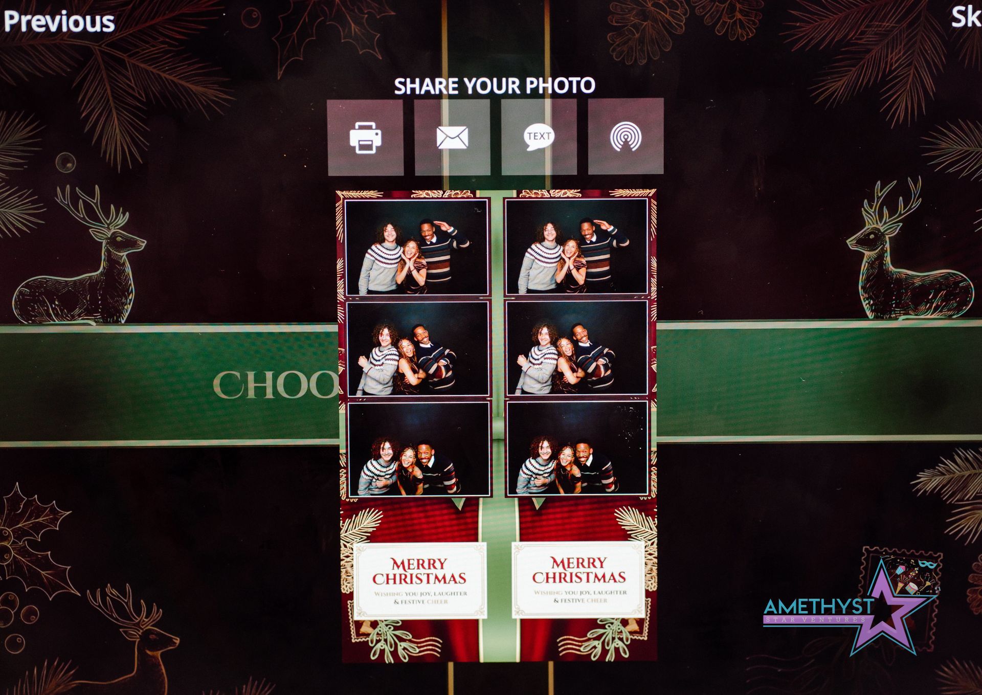 Photo-sharing booth with a green backdrop and multiple event photo strips displayed in the center.