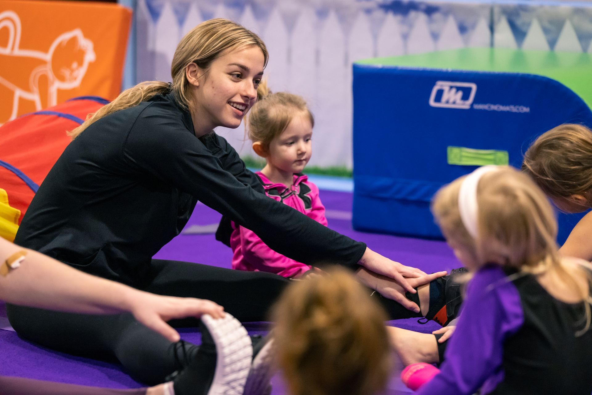 A group of people are doing gymnastics in a gym.