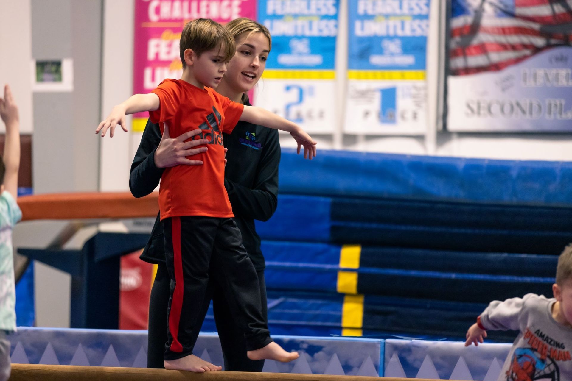 A group of people are doing gymnastics in a gym.