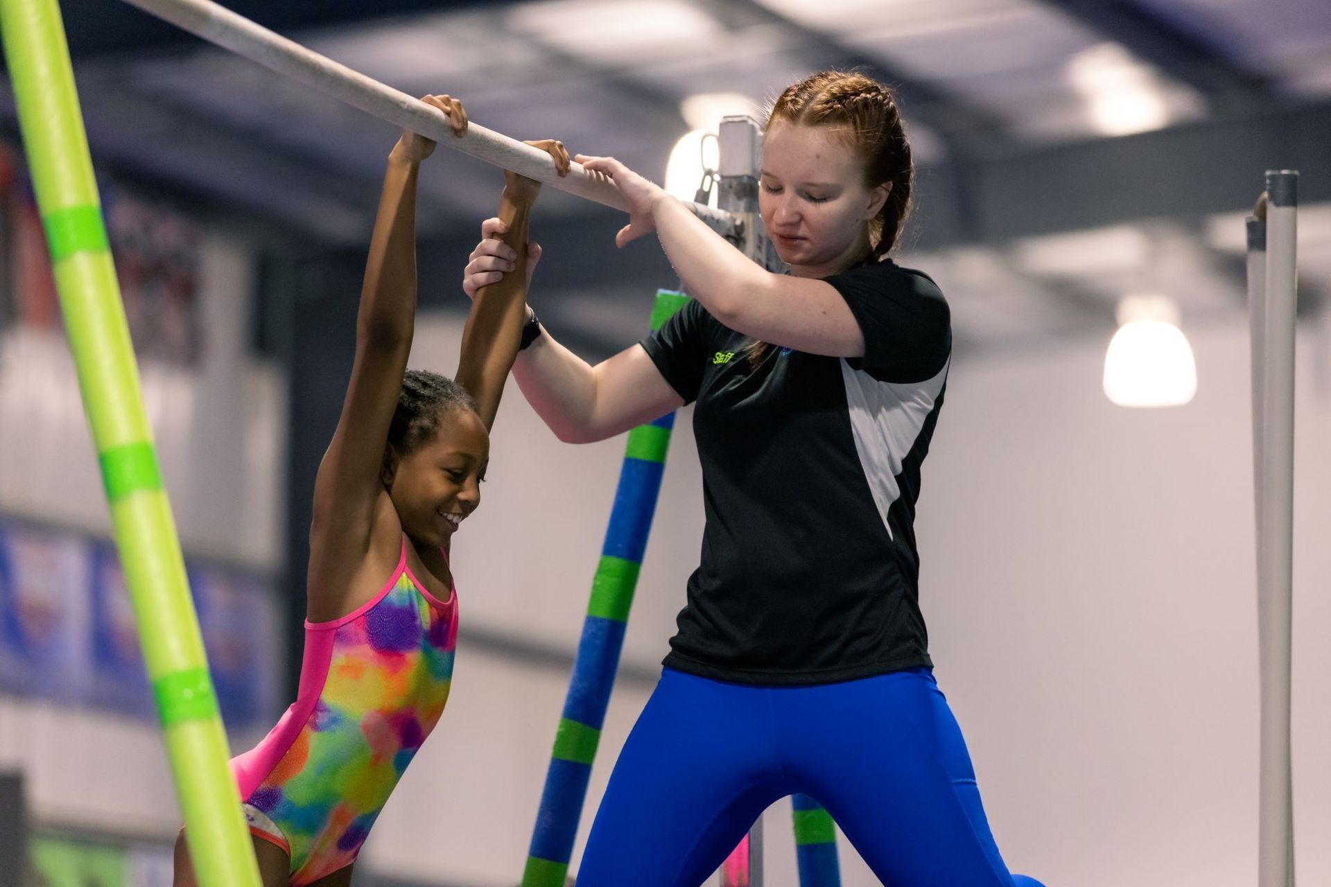 A group of people are doing gymnastics in a gym.