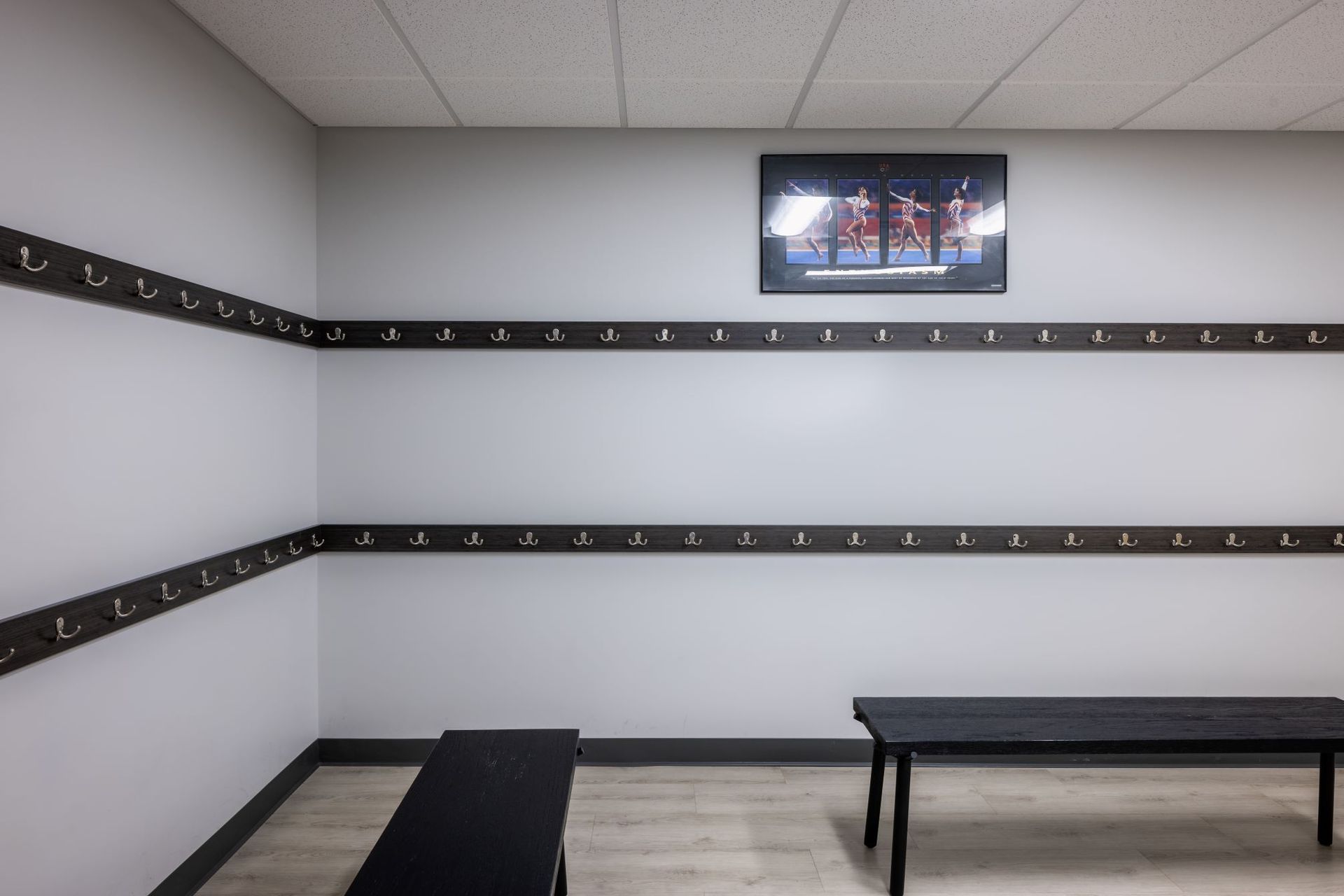 A locker room with a bench and hooks on the wall