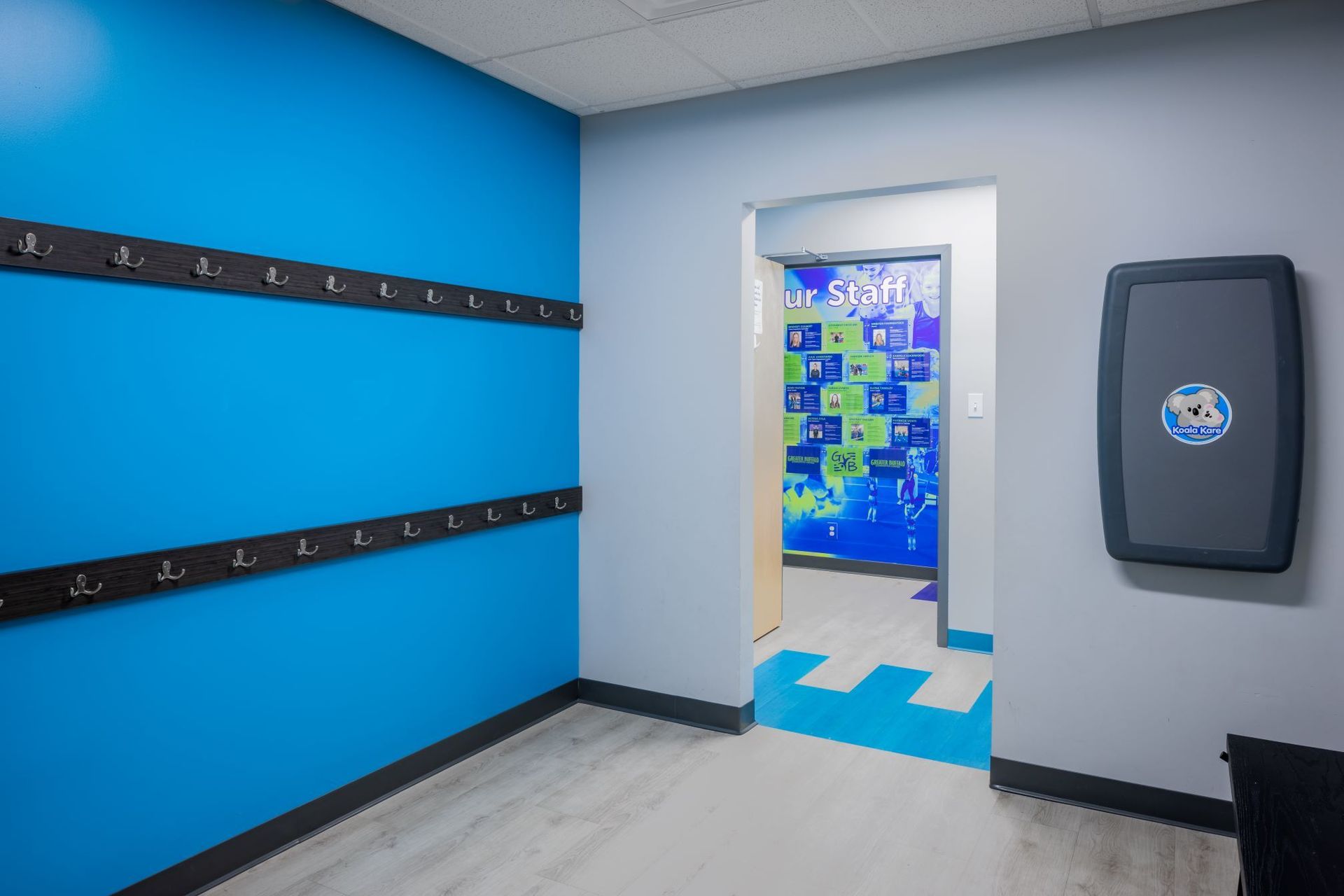 A room with blue walls and a changing table.