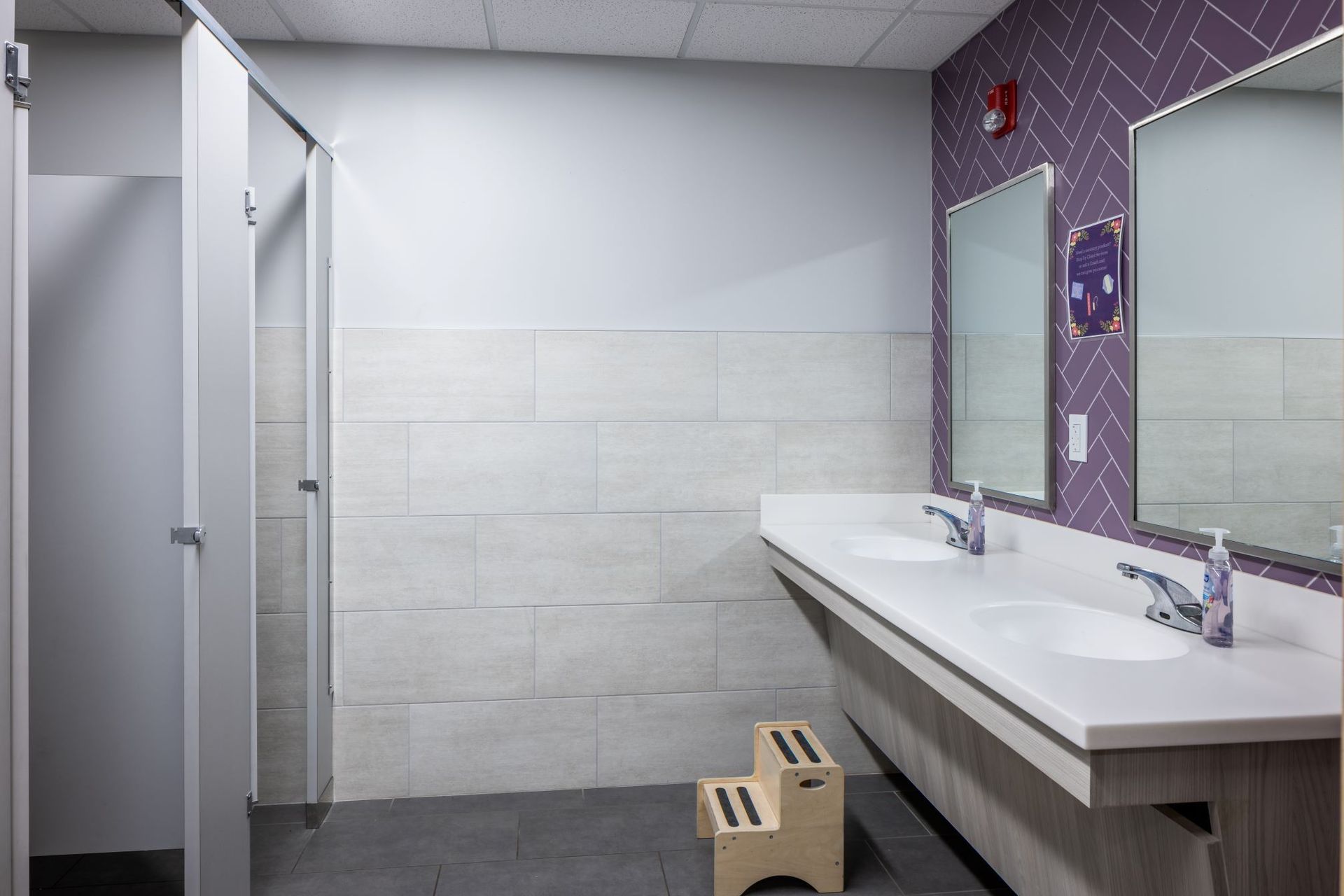 A bathroom with two sinks and two mirrors.