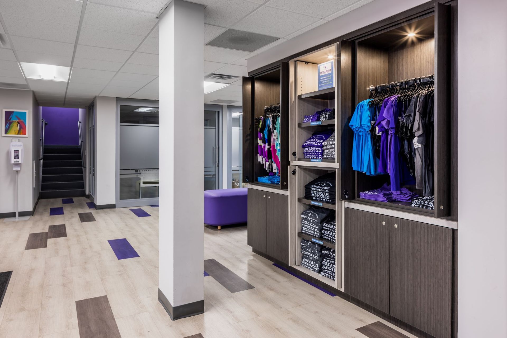 A room with a lot of shelves and clothes on them.