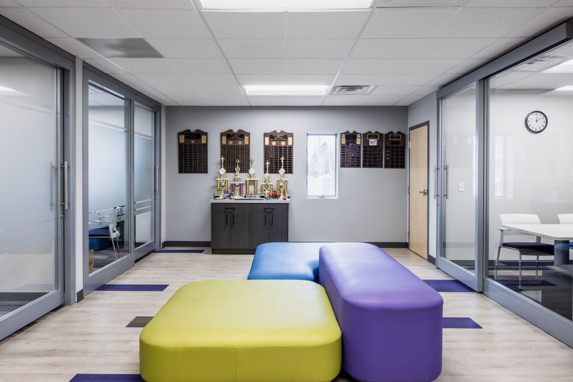 A room with a lot of windows and colorful furniture.