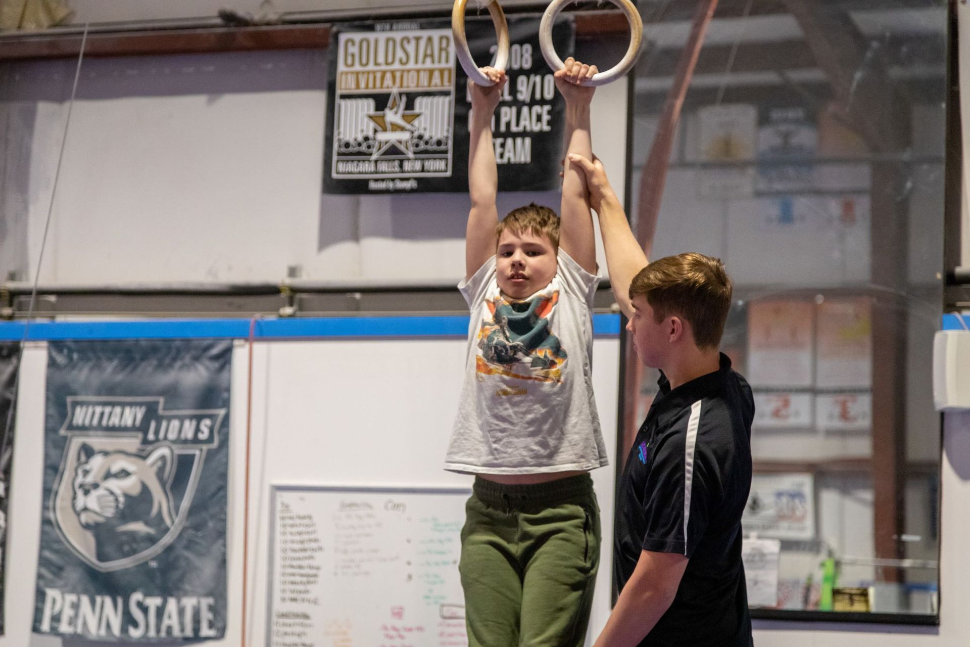 A group of people are doing gymnastics in a gym.