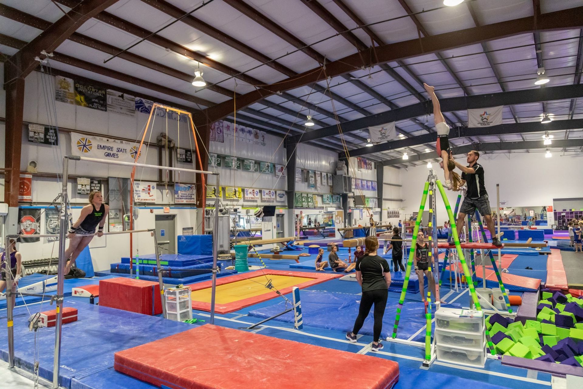 A group of people are doing gymnastics in a gym.