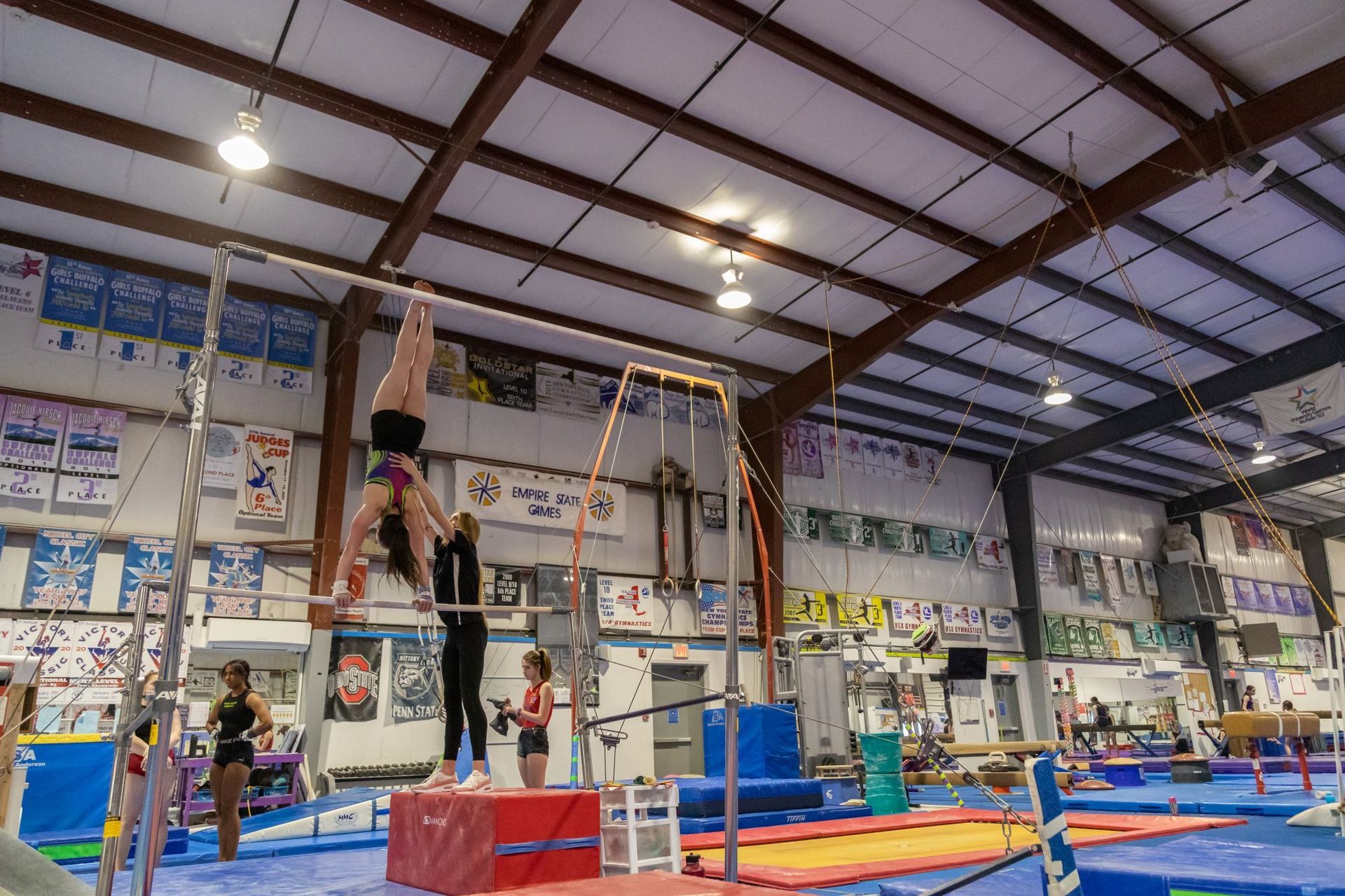 A group of people are doing gymnastics in a gym.