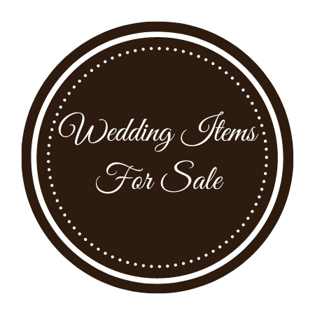 Brown circular sign with dotted border reading “Wedding Items For Sale” in white script