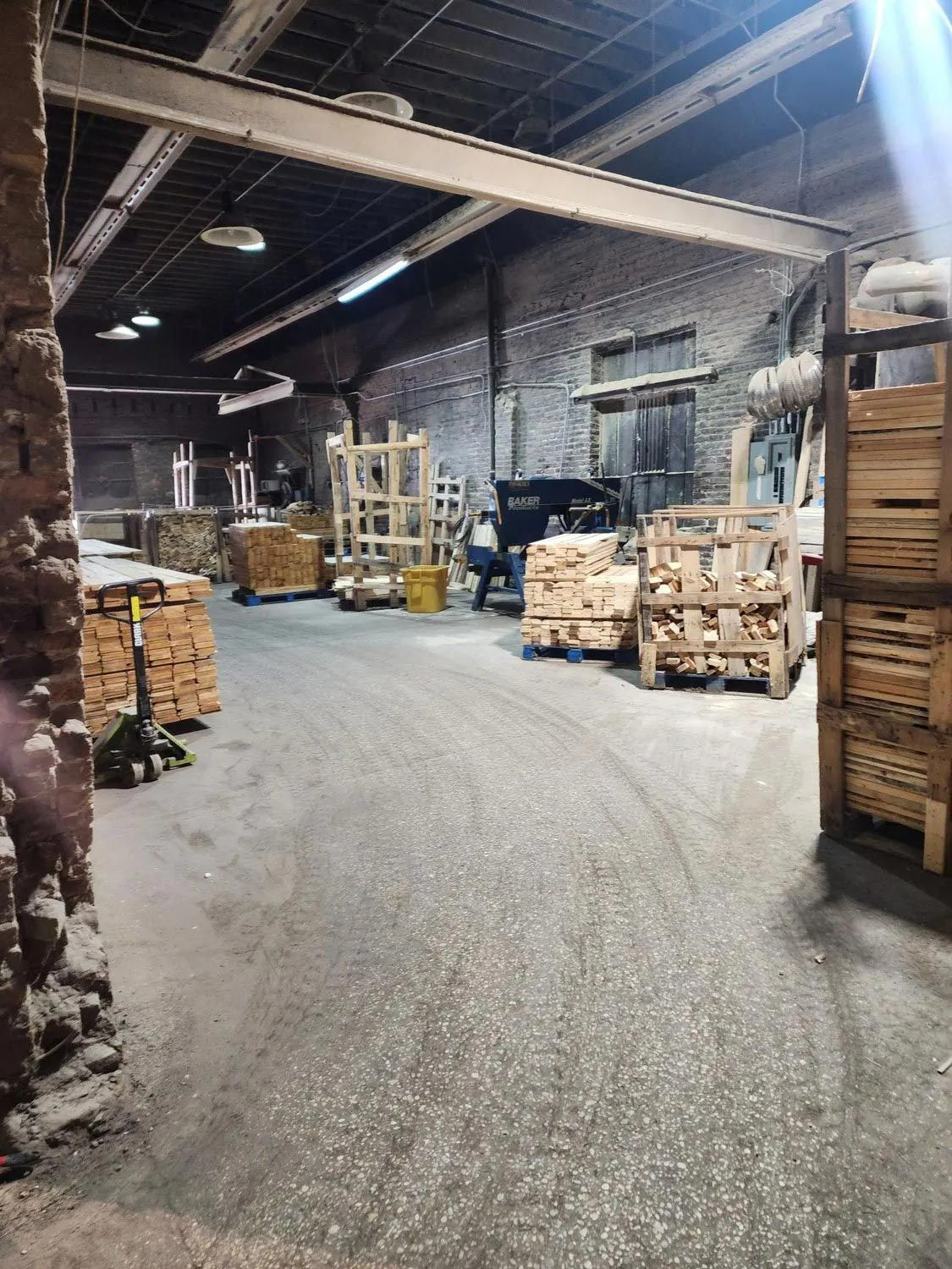 A large warehouse filled with lots of wooden pallets.