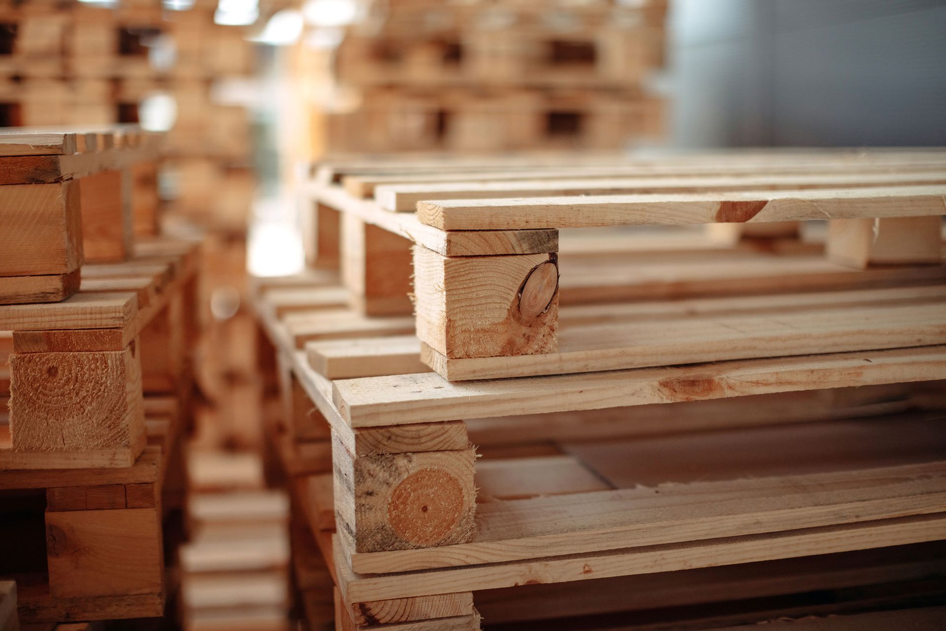 A stack of wooden pallets in a warehouse.