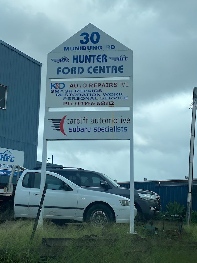 A White Car Is Parked In Front Of A Sign For Hunter Ford Centre — K & D Auto Repair in Cardiff, NSW