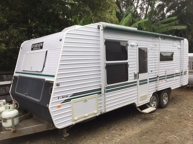 White and Grey Caravan Parked Outside, With Green Accents and Awning — Darren's Caravan Repairs in Warners Bay, NSW