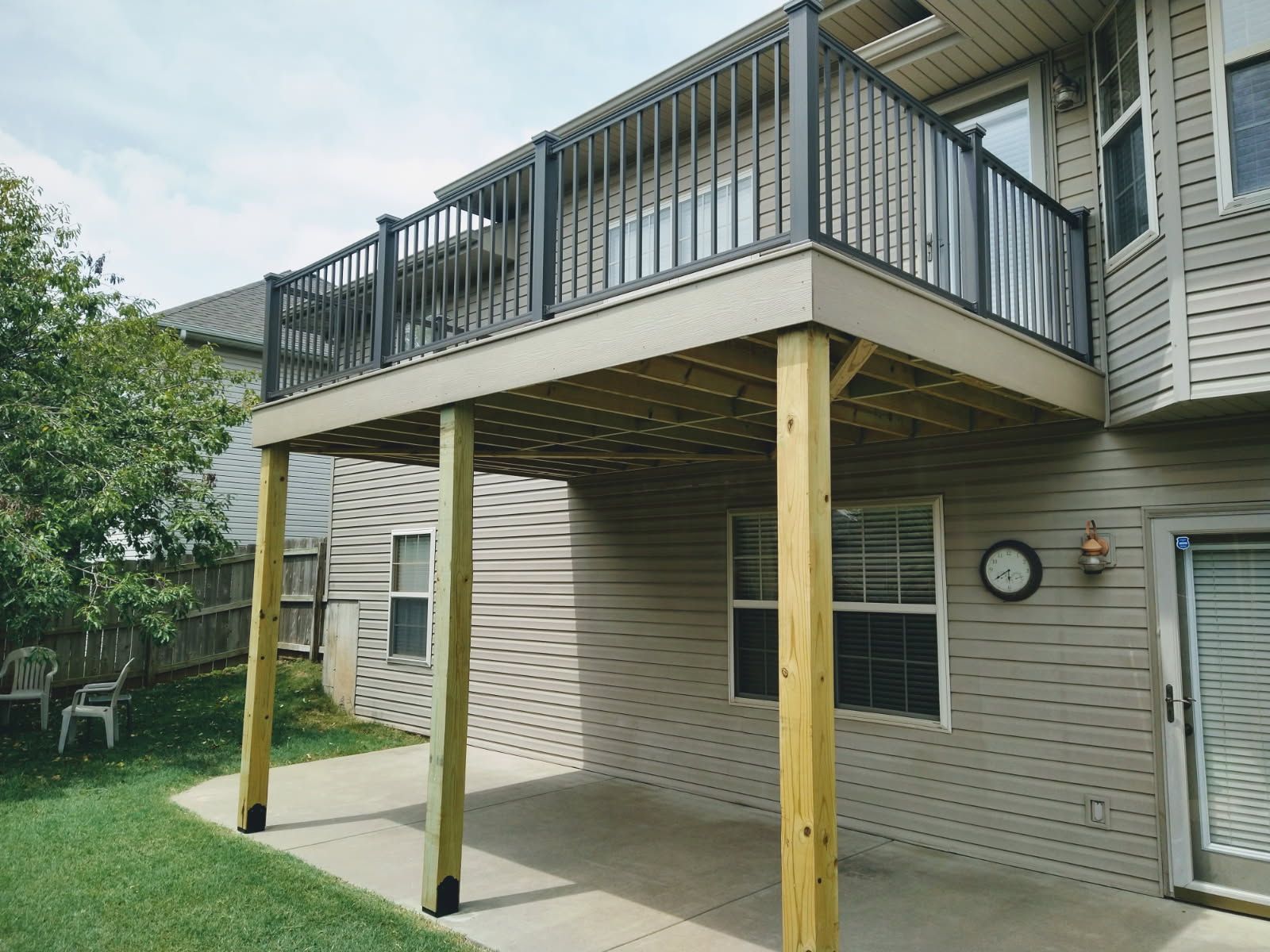Exterior view of a house with a window and a wooden deck.