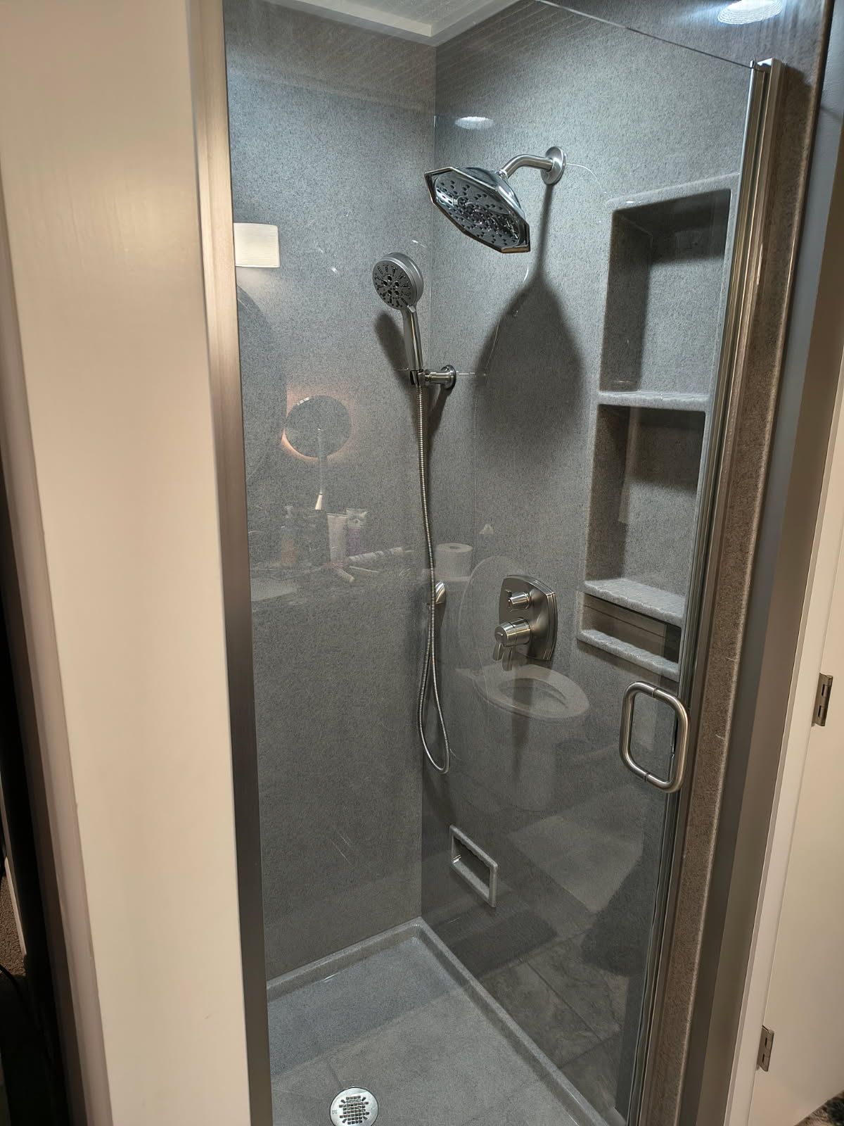 Vanity with a mirror, light fixture, and a white sink in a bathroom.