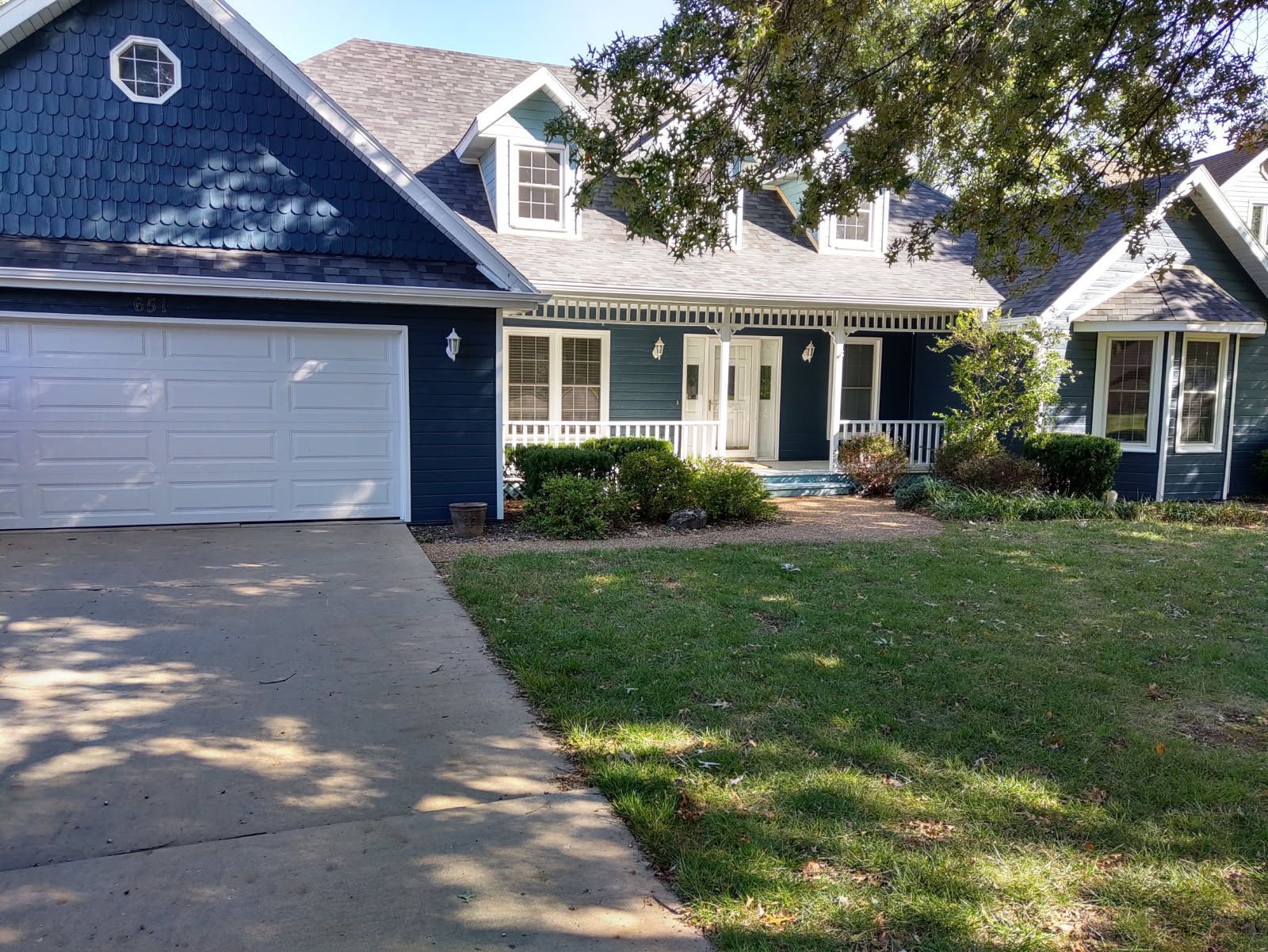 Exterior view of a house with a window and a wooden deck.