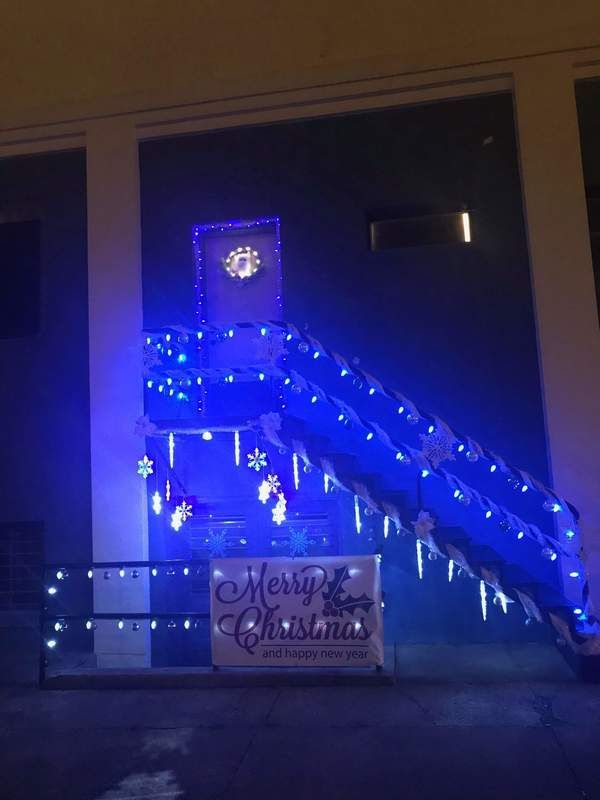 Blue Christmas lights decorate staircase with