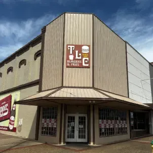 TLC Burgers & Fries restaurant exterior with a brown awning and sign.