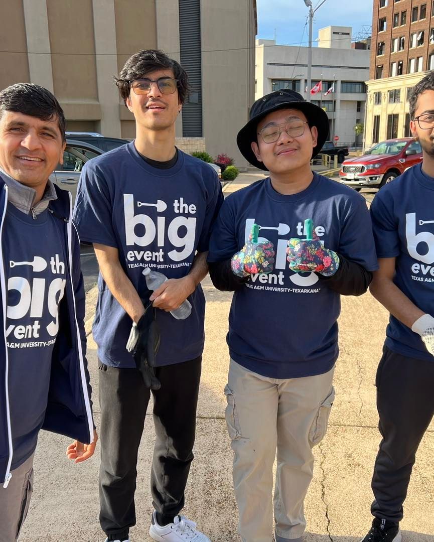 Four people in blue t-shirts with 