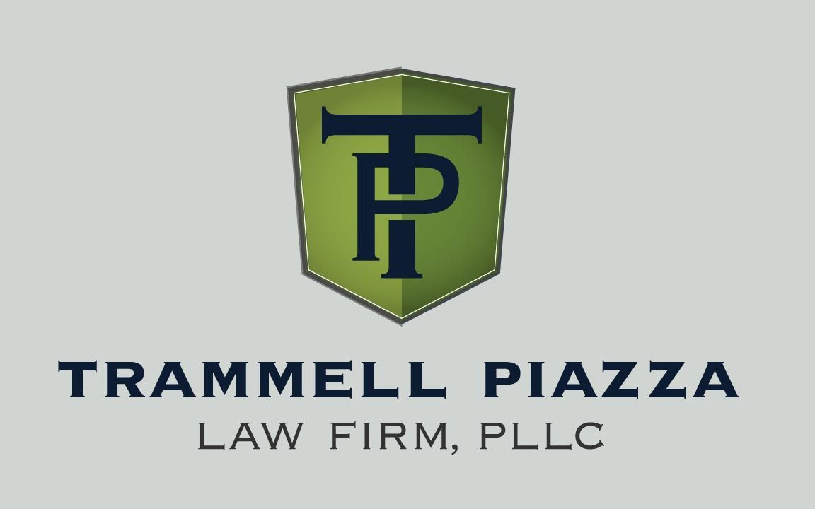 Logo for Trammell Piazza Law Firm; green and navy shield with
