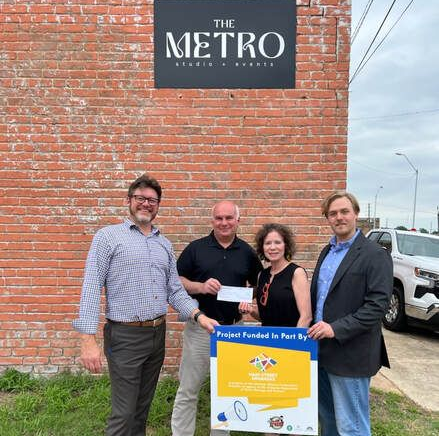 Four people stand outside 