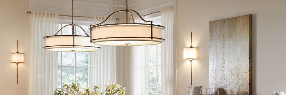 Dining room with two pendant lights, a window, and a piece of art on the wall.