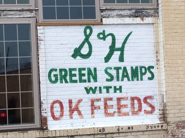 Sign on white brick wall: