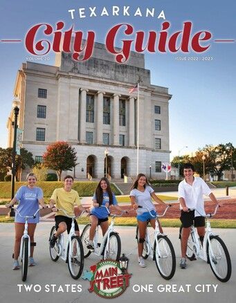 Texarkana City Guide cover: People on bikes in front of a building. 